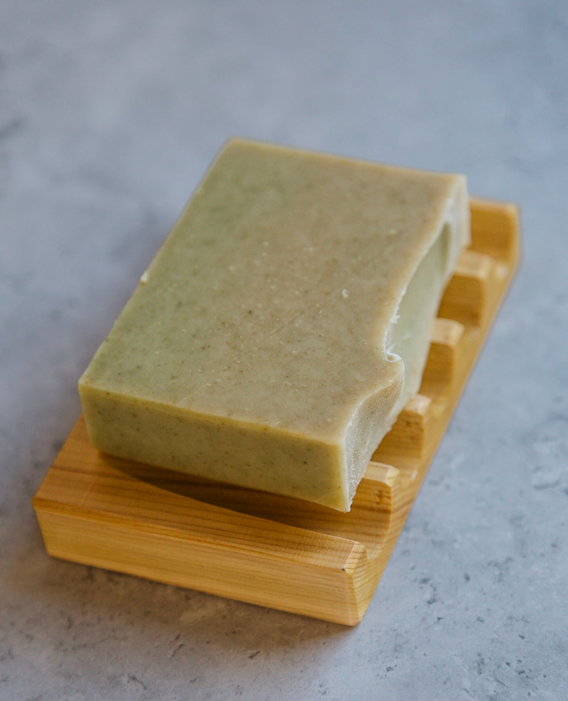 a bar of soap on a cedar soap deck