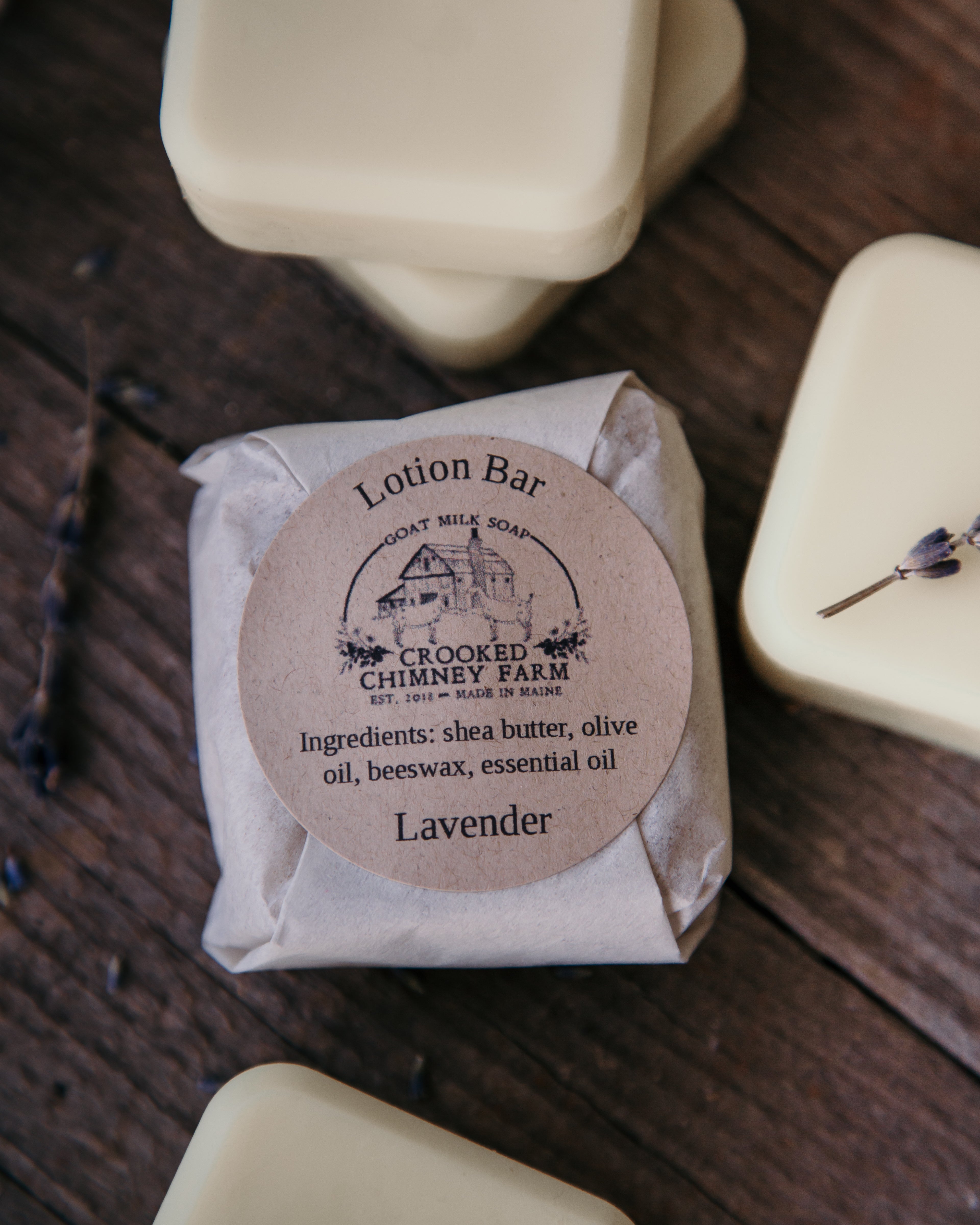 lavender lotion bar wrapped in tissue paper with ingredient label