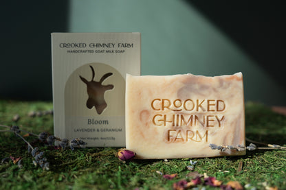 Crooked Chimney Farm Bloom (Spring 2026) soap on moss with green background. 