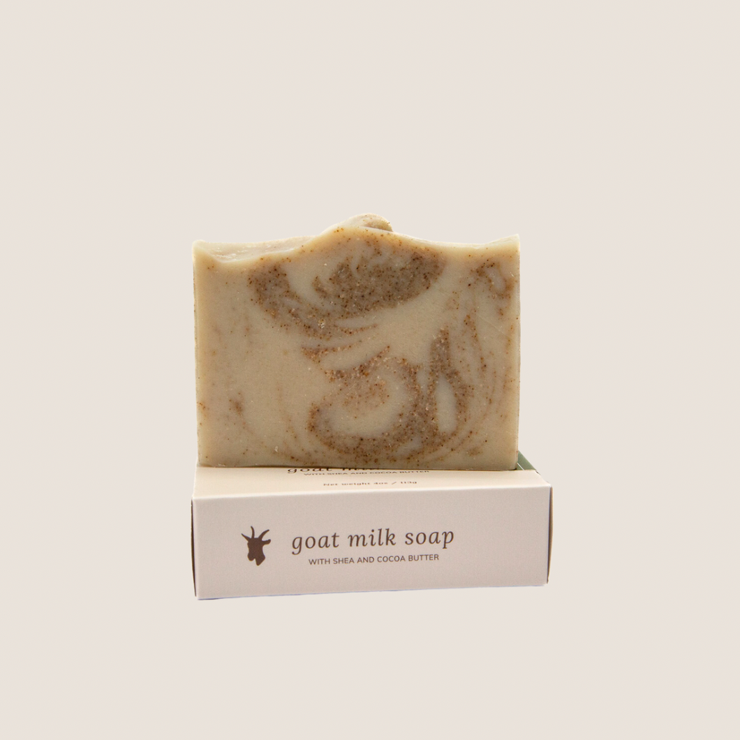 A bar of sea salt and kelp soap sitting on soap box