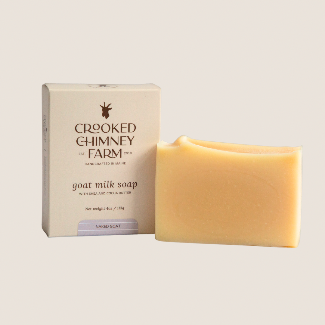 a box next to a bar of naked goat milk soap by crooked chimney farm