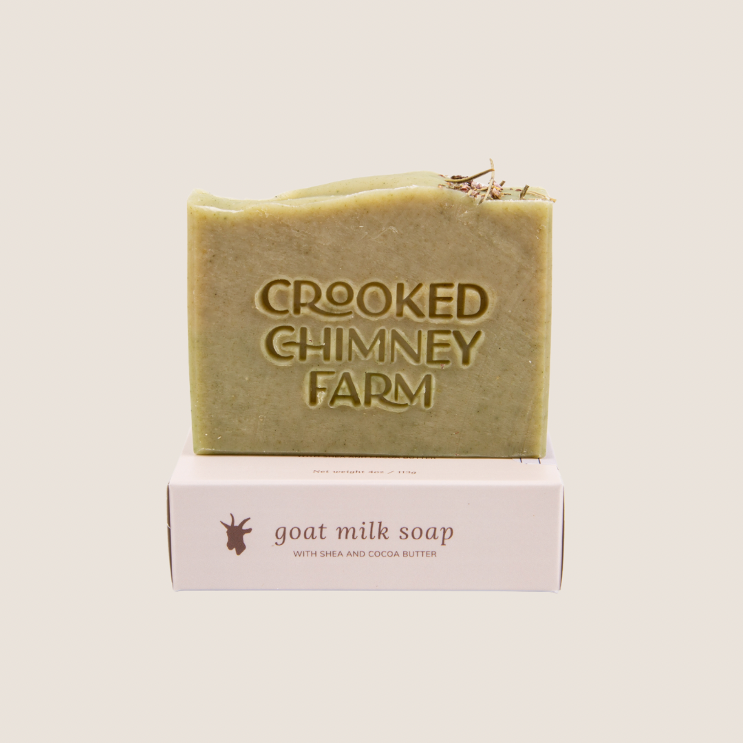 A bar of crooked chimney farm Spring Woodland goat milk soap set on top of soap box