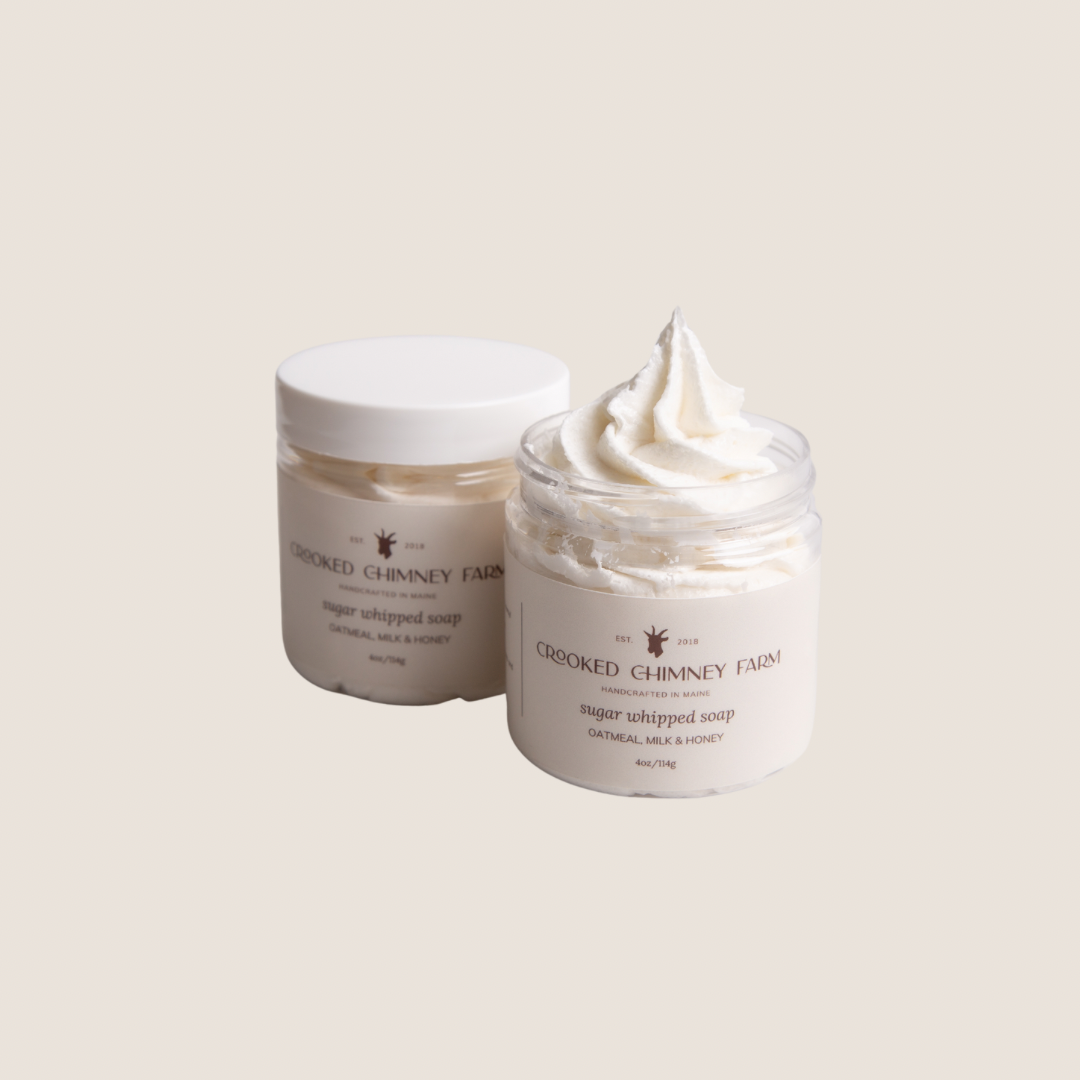 Two 4oz jars of oatmeal, milk and honey sugar whipped soap on white background. One with lid, one without lid.