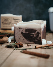 Load image into Gallery viewer, 4 bars of cinnamon cocoa soap that have brown swirls with white tops. 
