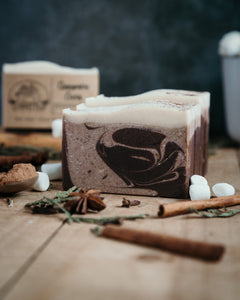 4 bars of cinnamon cocoa soap that have brown swirls with white tops. 