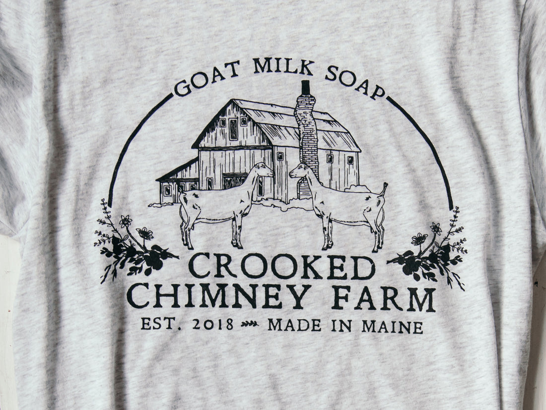 close up of crooked chimney farm tee logo on shirt.