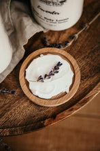 Load image into Gallery viewer, lavender lotion spread on dish with lavender sprig. 
